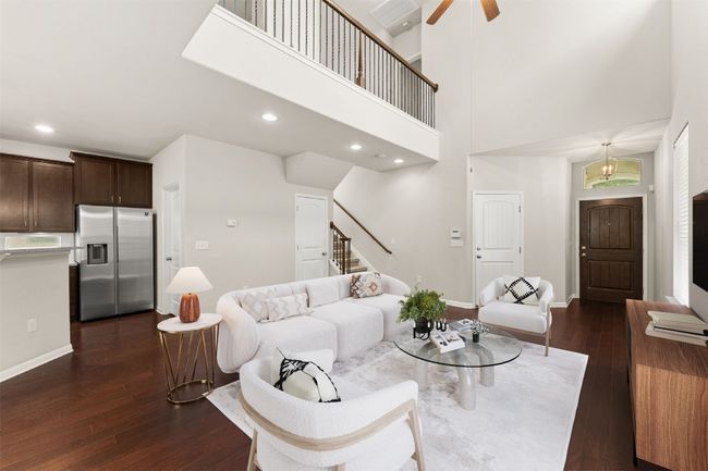 Living room with stairs, dark wood-style floors, a ceiling fan, baseboards, and recessed lighting. Virtual staging | Image 4