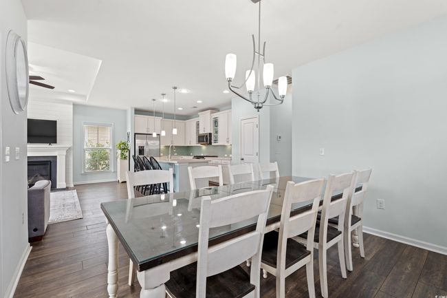 Dining area featuring many windows and an open concept. The upper deck is off of the dining area with pond view. | Image 21