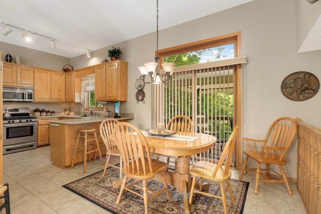 Eat-in kitchen/Informal dining room with deck access. | Image 15