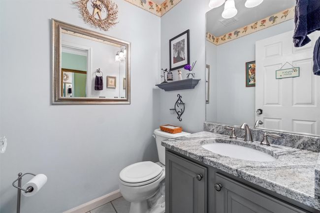 Powder Room, stone countertop, tile floor. | Image 15