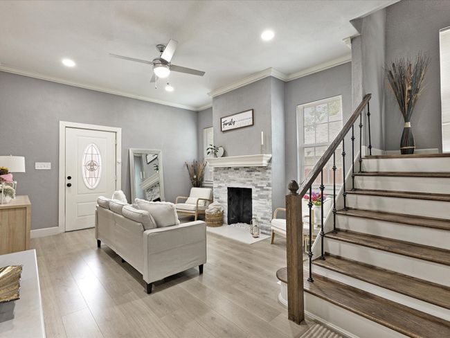 Living area with ceiling fan, stairs, healthy amount of natural light, recessed lighting, and light wood-style flooring | Image 7
