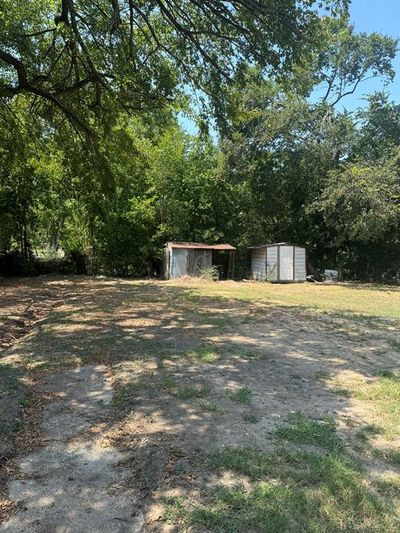 View of yard featuring a storage unit | Image 3