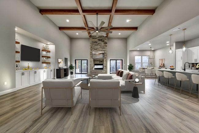 Living room featuring coffered ceiling, a stone fireplace, light hardwood / wood-style flooring, plenty of natural light, and beam ceiling | Image 4