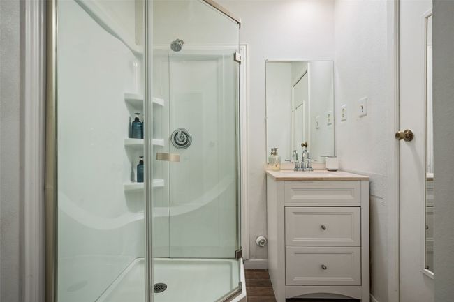 Bathroom featuring a stall shower and vanity | Image 13