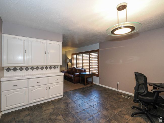 Office space featuring baseboards and a textured ceiling | Image 17