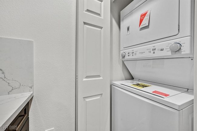Laundry room featuring brand new stacked washer / drying machine. | Image 20
