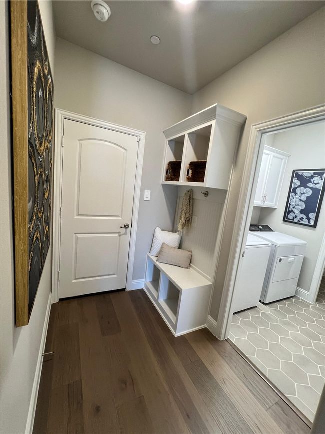 Mudroom featuring washing machine and clothes dryer and dark wood-style flooring | Image 10