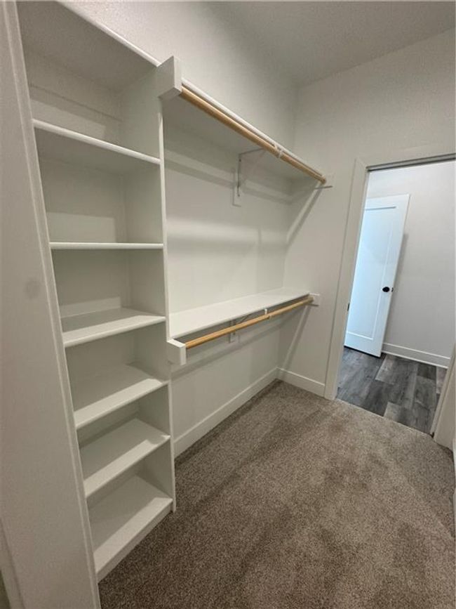 Spacious closet with dark colored carpet | Image 20