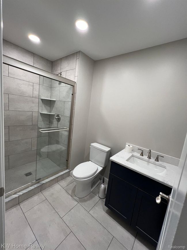 New porcelain tiled bathroom in basement. | Image 28