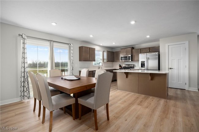 Dining space with light wood-style flooring, recessed lighting, and baseboards | Image 21