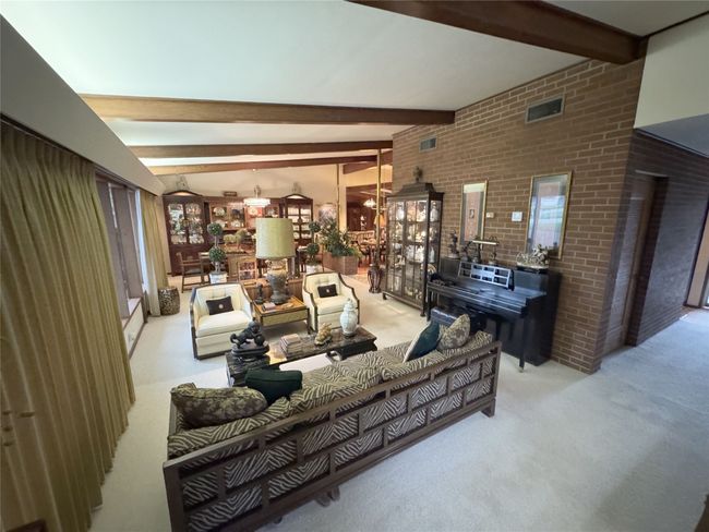 Carpeted living area with beam ceiling | Image 21