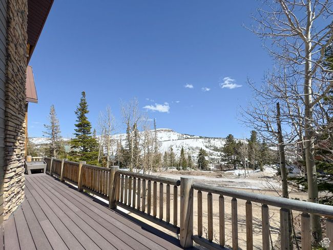 Snow covered deck featuring a mountain view | Image 51