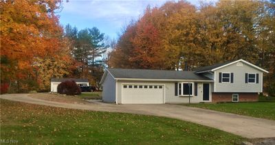 View of front with a front yard and a garage 2nd garage in back. | Image 1