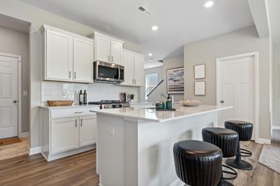 (Photo of model, actual homes finishes will vary) Imagine entertaining in this bright and open kitchen. | Image 2