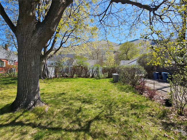 View of yard featuring a mountain view and fence | Image 30