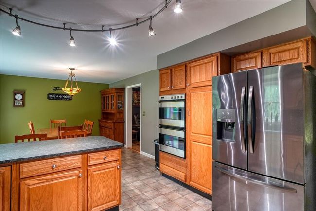 Kitchen featuring appliances with stainless steel finishes, hanging light fixtures, and rail lighting | Image 18