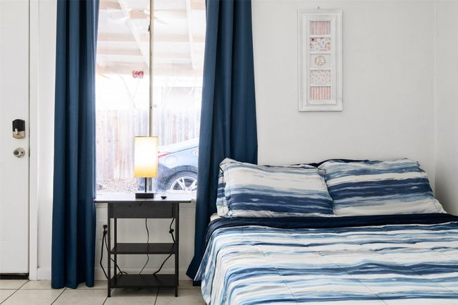 Bedroom with tile patterned floors | Image 5