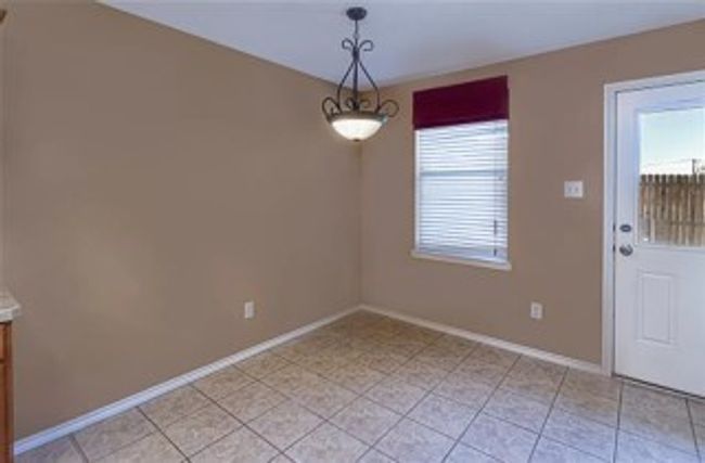 Unfurnished dining area featuring healthy amount of natural light and light tile patterned flooring | Image 7