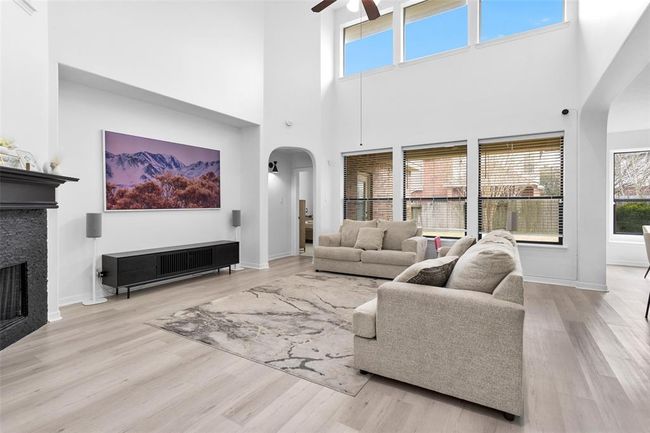 The living space provides high ceilings with a wall of windows offering an abundance of natural light. | Image 10
