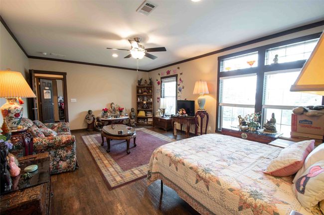 Second master Bedroom featuring wood finished floors, crown molding, a ceiling fan, and recessed lighting | Image 21