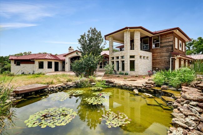 The seller added the Cut Native Limestone Rock, The Standing Seam Metal Roof with the Water Retention System, the 50, 000 Gallon Water Storage Tank, The Lilly/ Koi Pond, Enclosed the Hobby Room & Hot Tub areas and the EV Charger and the Green House. Humbly and Successfully leaving a Legacy of Conservation on the this High Hill Country Estate in the Legendary Ruby Ranch. | Image 26