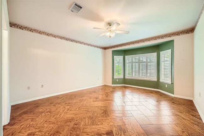 Spare room with a ceiling fan and baseboards | Image 15