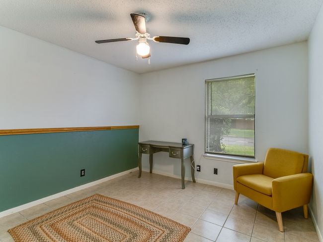 Living area featuring tile patterned flooring, a ceiling fan, and a textured ceiling | Image 19
