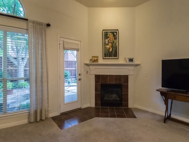Unfurnished living room with a fireplace, carpet, and baseboards | Image 18