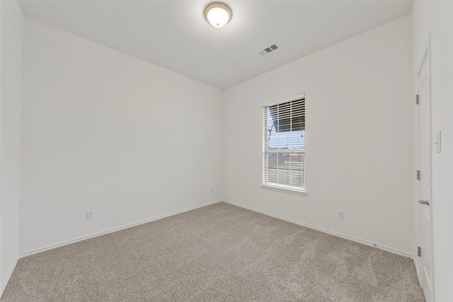 Carpeted spare room featuring baseboards and visible vents | Image 31