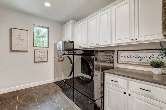 Laundry room with cabinet space | Image 31