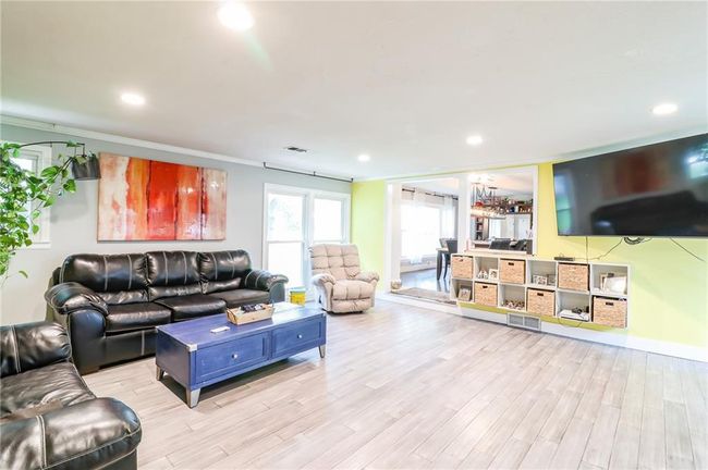 Living room featuring light wood finished floors, recessed lighting, and crown molding | Image 6