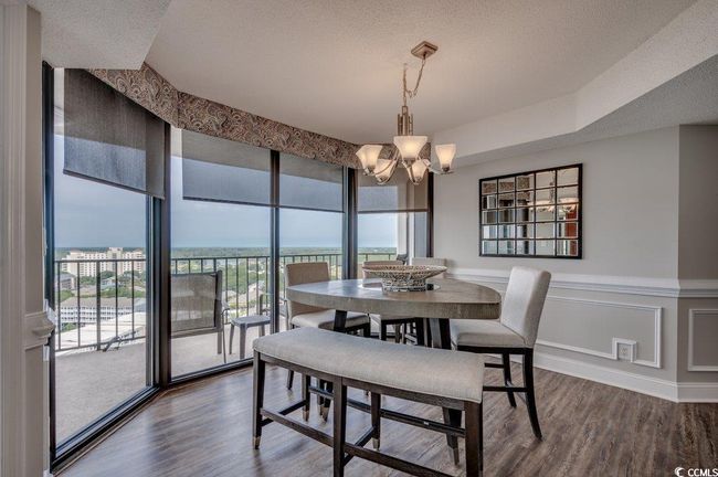 Dining area with an inviting chandelier, hardwood / wood-style floors, and a textured ceiling | Image 11