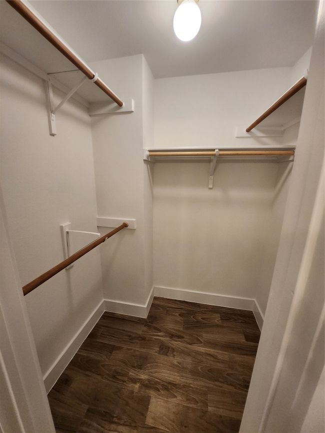 Spacious closet featuring dark wood-style floors | Image 8