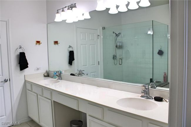 Full bath with double vanity, a sink, and a shower stall | Image 16