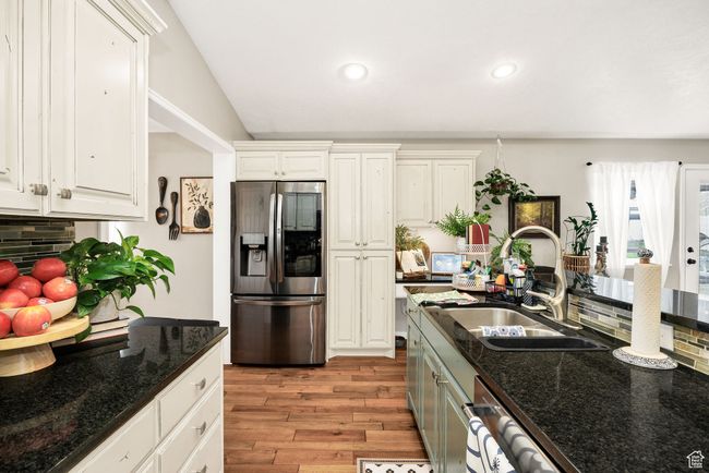 Kitchen with recessed lighting, stainless steel appliances, backsplash, a sink, and light wood-type flooring | Image 7