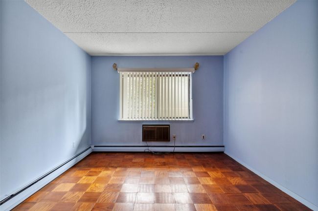 Spare room with a baseboard radiator, a textured ceiling, baseboard heating, and a wall mounted air conditioner | Image 18