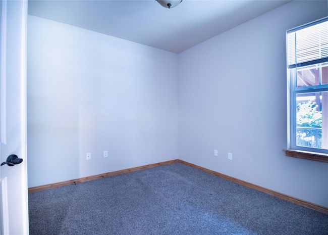 Carpeted empty room featuring baseboards | Image 16