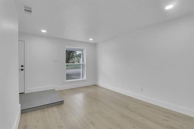 Spare room featuring light wood-type flooring | Image 3