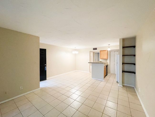 Unfurnished living room featuring light tile patterned floors and baseboards | Image 7