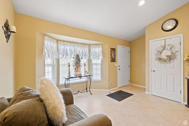 Foyer entrance with vaulted ceiling, a wealth of natural light, and light tile patterned floors | Image 7