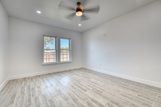 Empty room with light hardwood / wood-style flooring and ceiling fan | Image 24