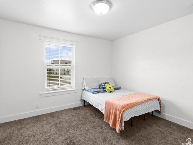 Carpeted bedroom with baseboards | Image 8