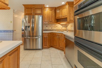 A double oven, stainless appliances and tile floor | Image 3