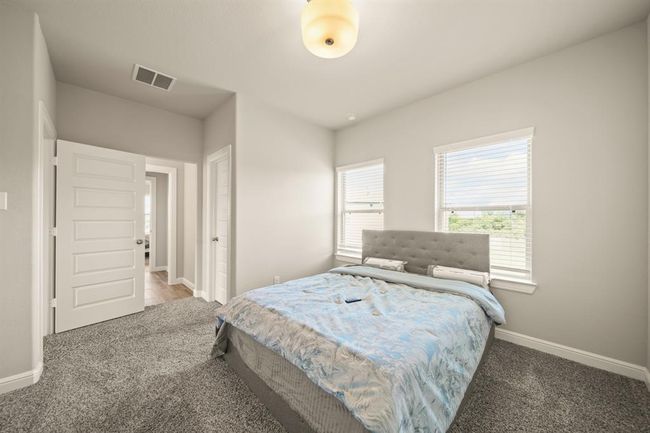 Corner bedroom with charming neighborhood views and large windows for ample sunlight. | Image 31