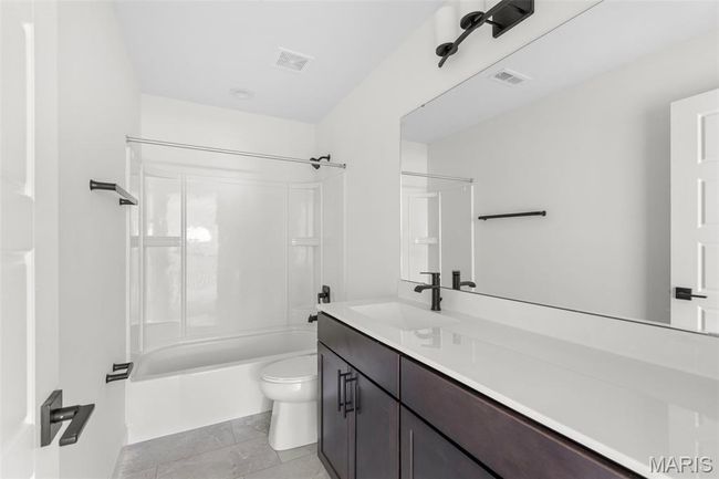 Bathroom featuring vanity and shower / bath combination | Image 8