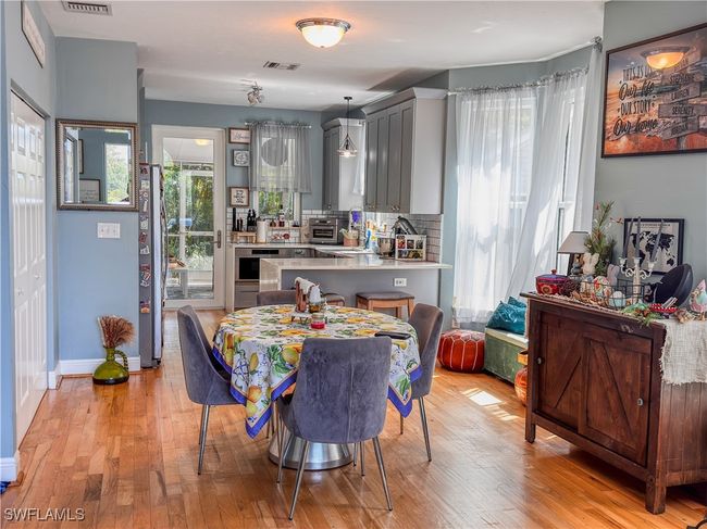 Dining room with baseboards, visible vents, a toaster, and light wood finished floors | Image 8