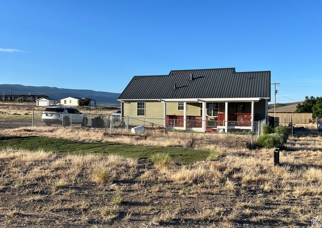 Back of property featuring a metal roof and a mountain view | Image 12