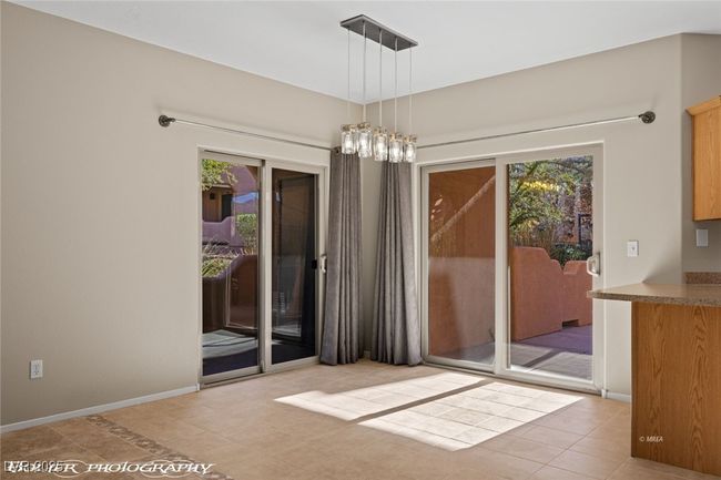 Unfurnished dining area featuring baseboards, tile patterned flooring, and plenty of natural light | Image 7