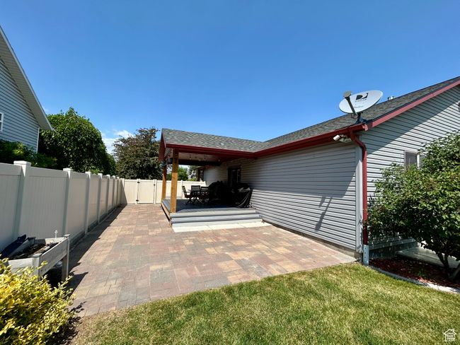 Fenced backyard featuring a patio area and a gate | Image 31