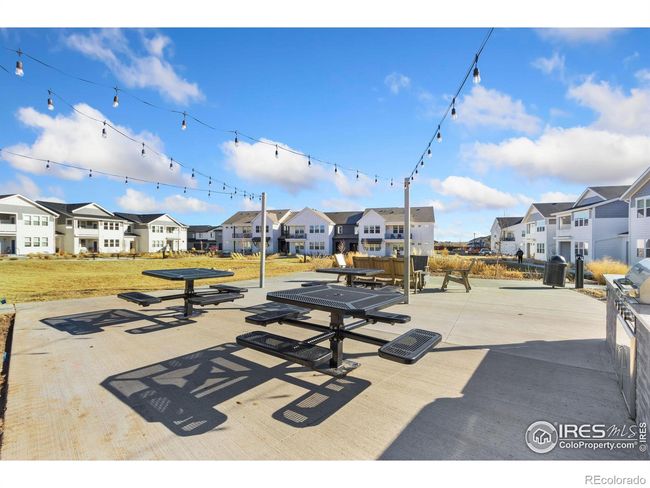 Firepit area with BBQ, additional seating, and party lights | Image 28